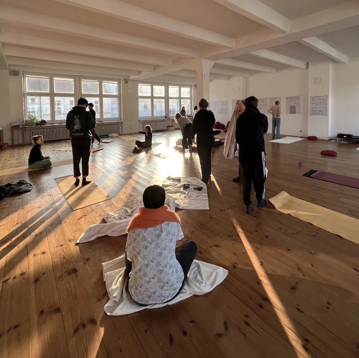 Retreat participants practising in a bright hall